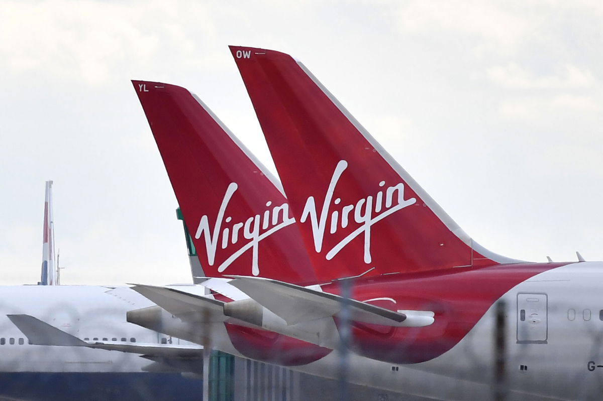 <i>BEN STANSALL/AFP via Getty Images</i><br/>Tailfins of parked Virgin Atlantic passenger aircraft are pictured on the apron at Heathrow Airport