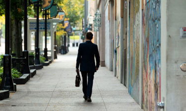 Employers had a rough 2021. Now here comes Omicron. A person walks along State Street in Madison