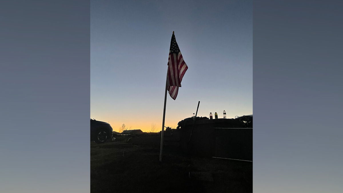 <i>Ashley Killough/CNN</i><br/>An American flag is seen in the rubble of Marsha Hall's home. It is one of 25 flags that used to fly in the front yard year-round.