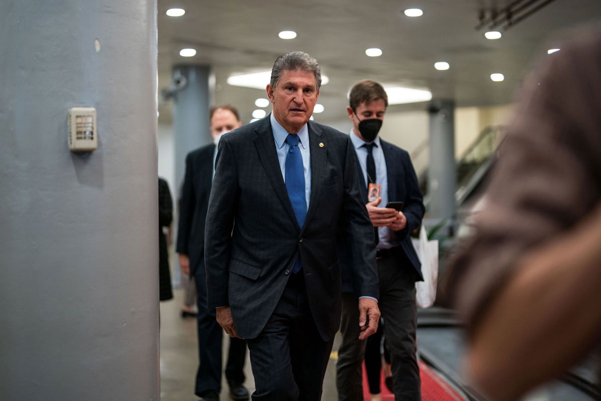 <i>Kent Nishimura / Los Angeles Times/Getty Images</i><br/>Sen. Joe Manchin leaves the Senate Chamber on Capitol Hill on December 15