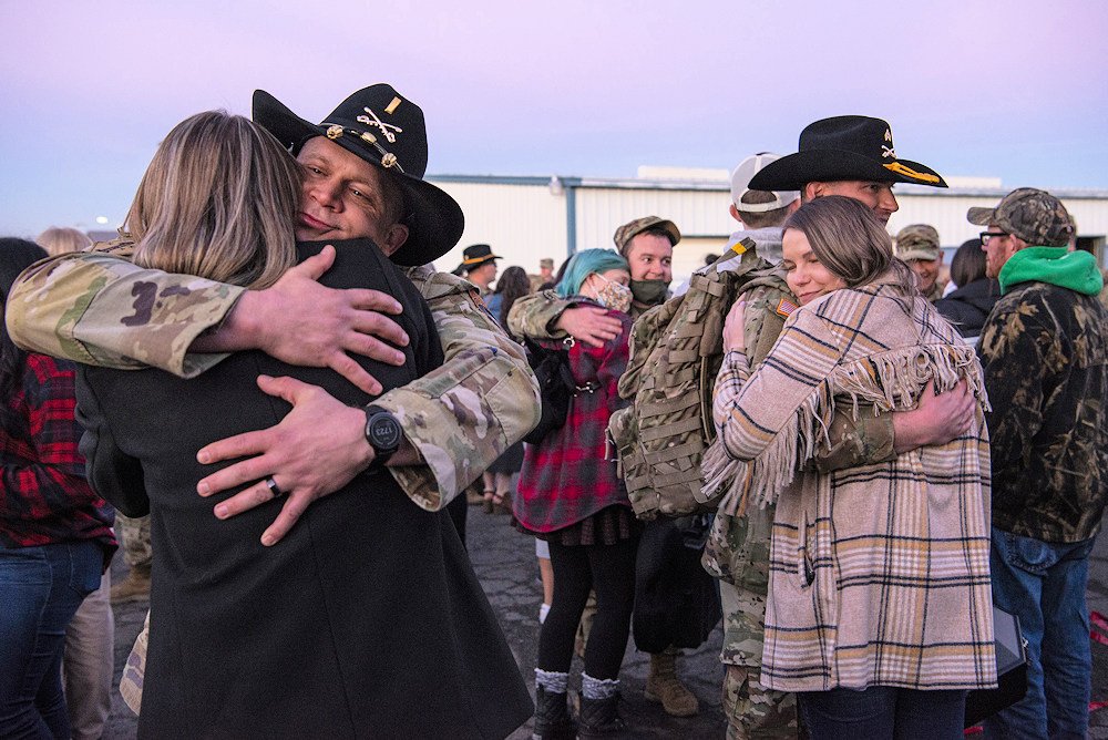 Family members embrace and greet Oregon Army National Guard Soldiers returning from deployment in Poland at the Jackson Armory in Portland