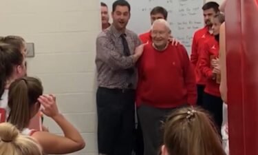 Girls basketball coach Adam Jones (left) introduces his team to  his old coach