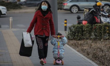 China's birth rate drops for a fifth straight year to record low. A girl here rides on a kids scooter in Beijing