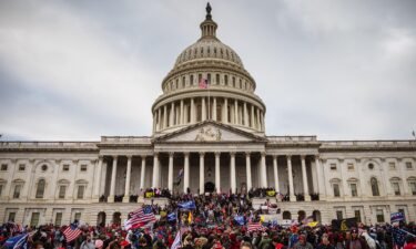 Democrats weigh how to talk about January 6 on the 2022 campaign trail as a large group of pro-Trump protesters stand on the East steps of the Capitol Building after storming its grounds on January 6