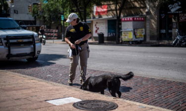 An officer surveys the scene of a shooting on June 12