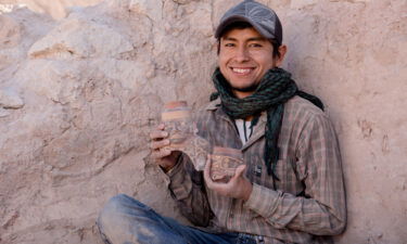 Maico Aybar Villalobos holds fragments of a Robles Moqo vessel that he excavated from Quilcapampa.