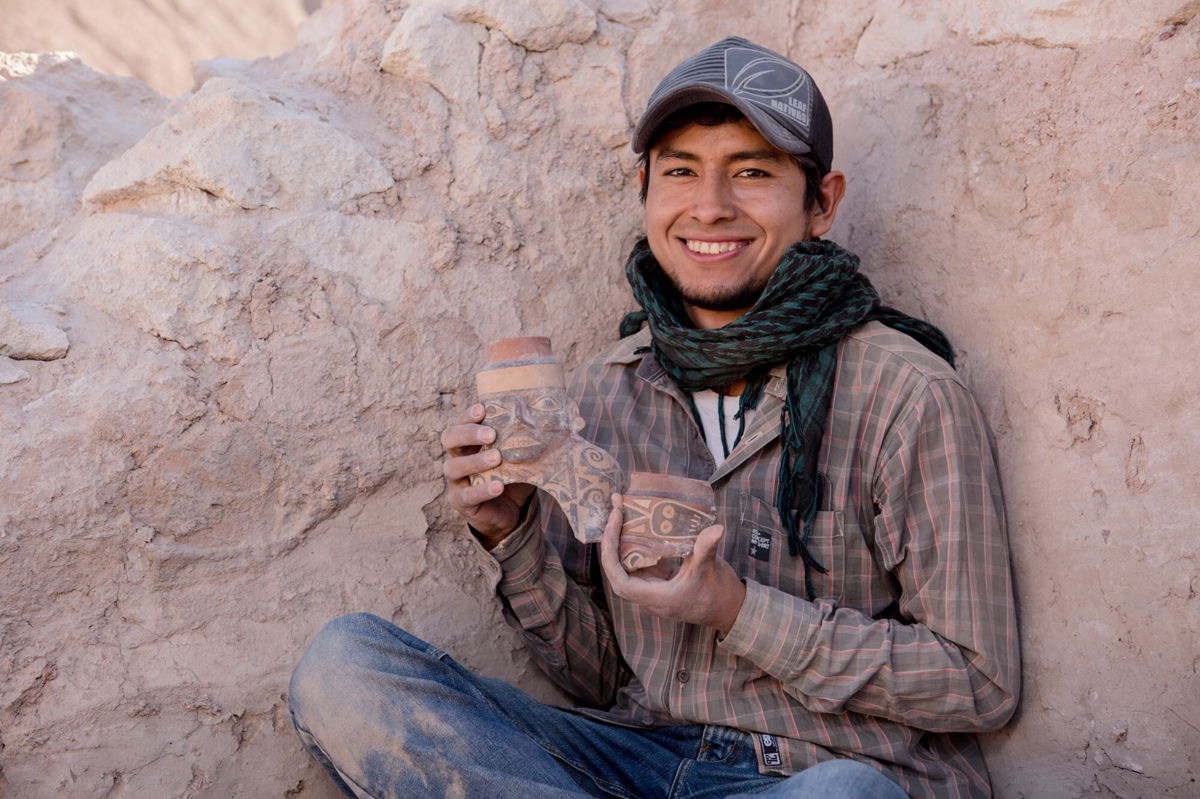 <i>Lisa Milosavljevic/Royal Ontario Museum</i><br/>Maico Aybar Villalobos holds fragments of a Robles Moqo vessel that he excavated from Quilcapampa.