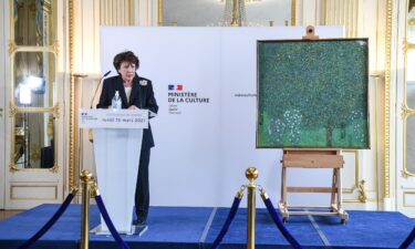 French Culture Minister Roselyne Bachelot stands next to a Nazi-pillaged artwork