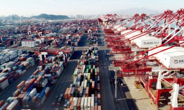Aerial view of shipping containers sitting stacked at Asia's first fully automated container terminal of Qingdao Port on January 14