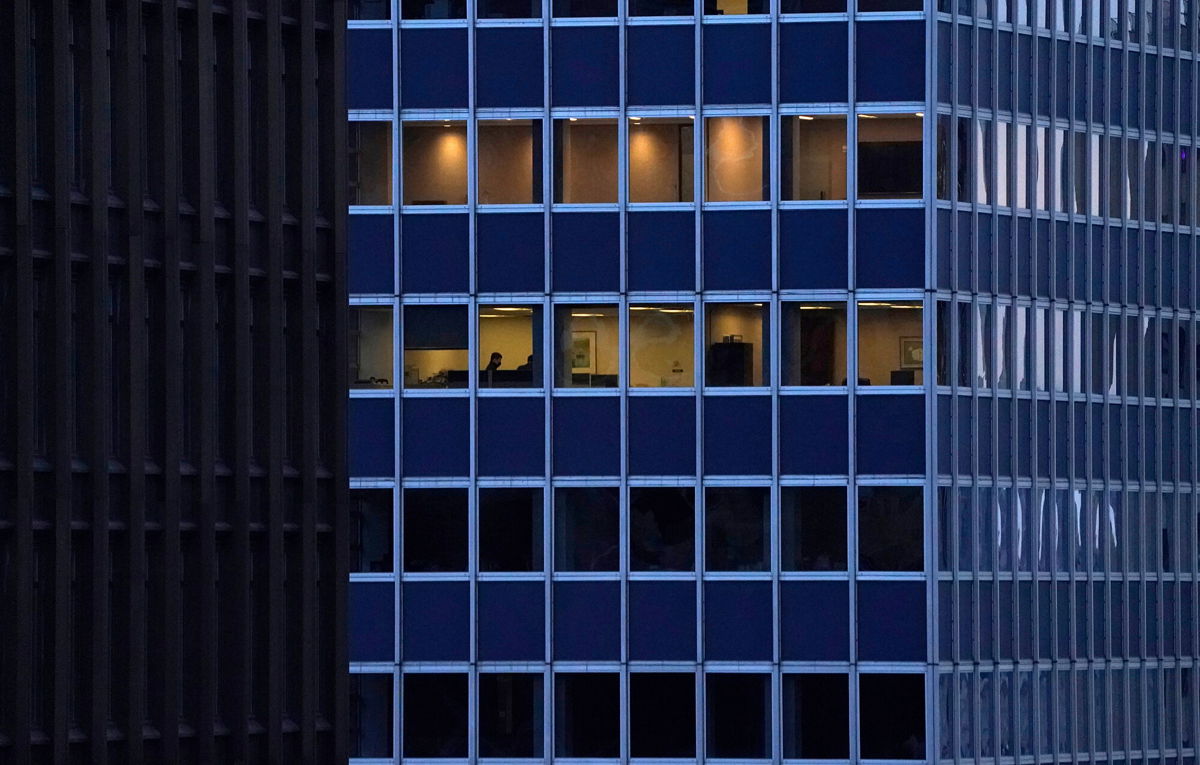 <i>Timothy A. Clary/AFP/Getty Images</i><br/>Employees work in an office building in Midtown New York City