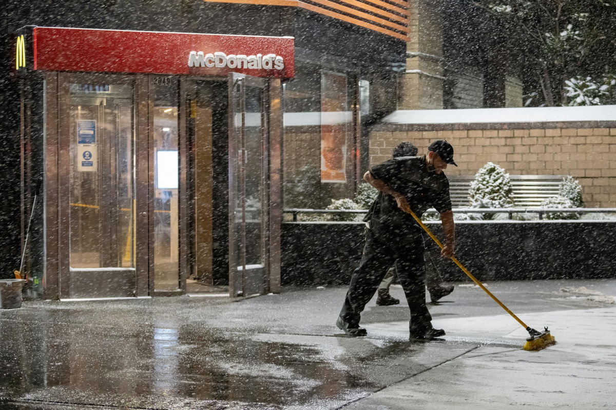 <i>Alexi Rosenfeld/Getty Images</i><br/>Companies are obsessed over worker pay. A McDonald's employee here sweeps snow away from the entrance on January 28