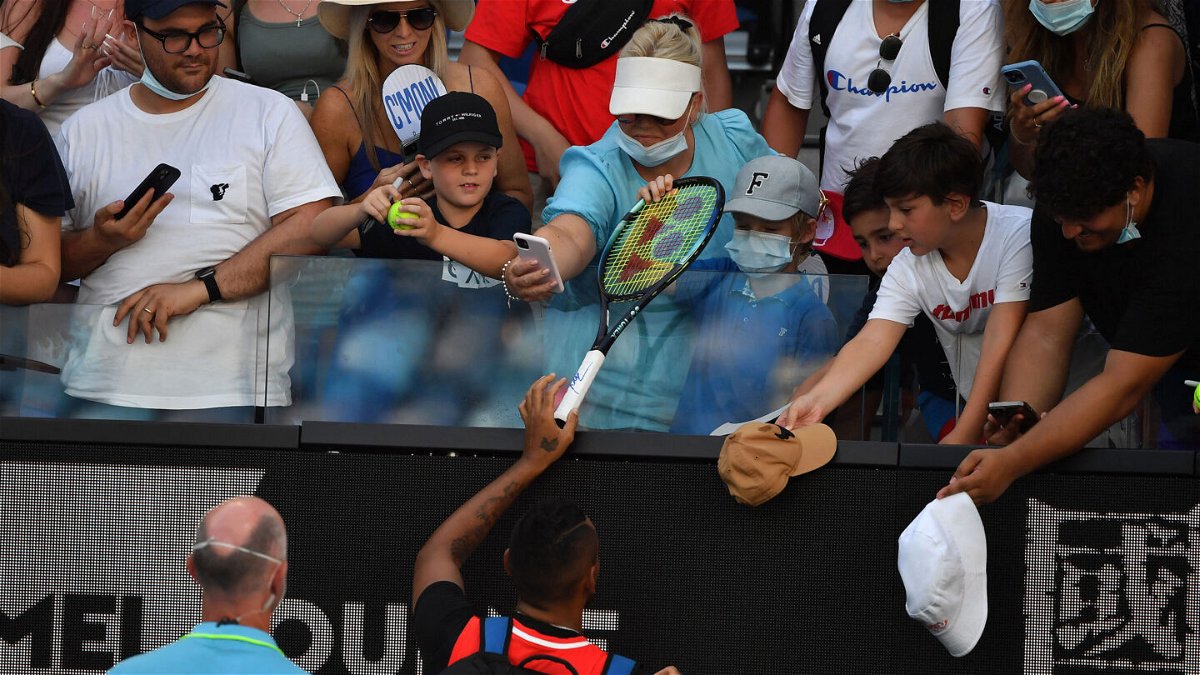 <i>Paul Crock/AFP/Getty Images</i><br/>Kyrgios (bottom C) gives a racket to a boy he had hit with a tennis ball.