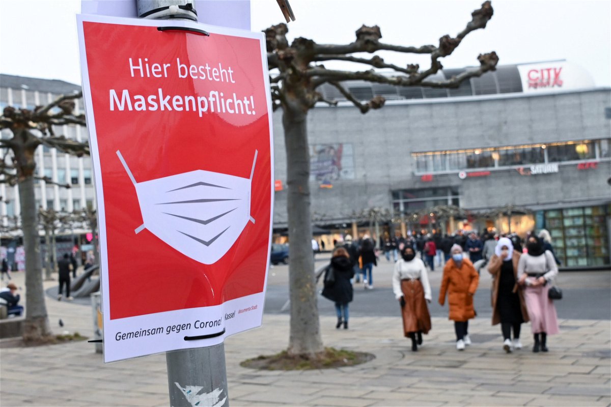 <i>Uwe Zucchi/dpa/picture alliance/Getty Images</i><br/>A sign in the German city of Kassel reminds people to wear a mask.