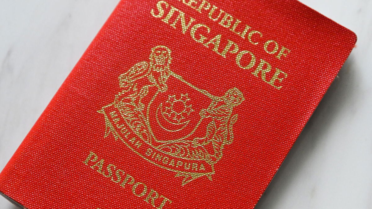 <i>ROSLAN RAHMAN/AFP via Getty Images</i><br/>A photo illustration shows a Singapore passport in Singapore on March 29
