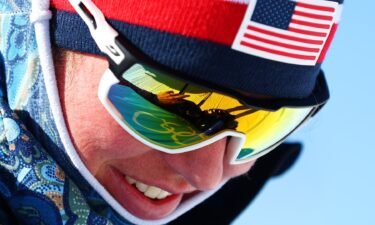 Cross-country skier Caitlin Patterson looking down smiling with sunglasses on at training day