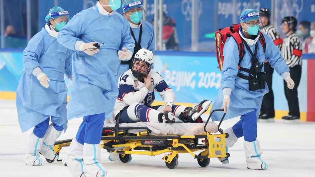 An injured Brianna Decker is stretchered off against Finland.