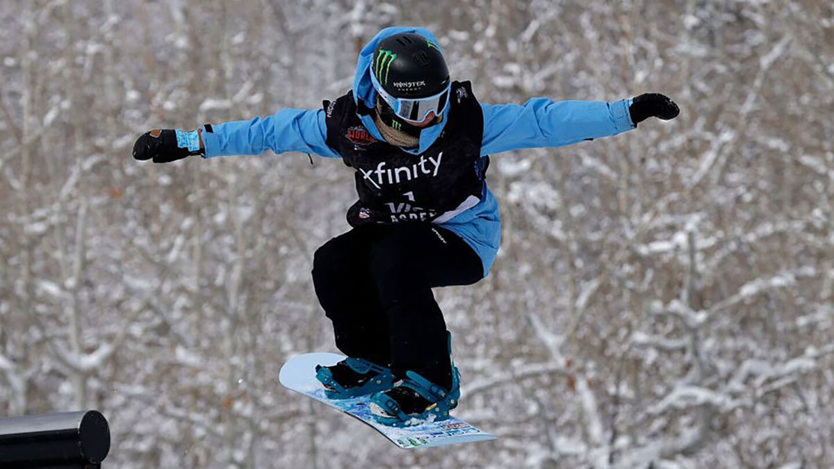 A snowboard slopestyle rider competes