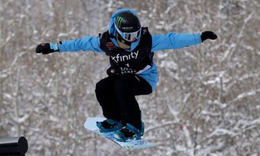 A snowboard slopestyle rider competes