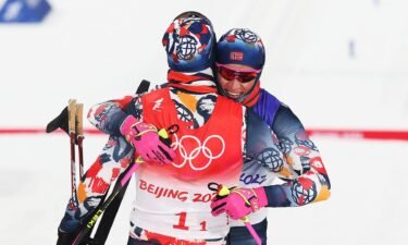 Erik Valnes (L) and Johannes Hoesflot Klaebo of Team Norway celebrate winning the gold medal during the Men's Cross-Country Team Sprint Classic Final
