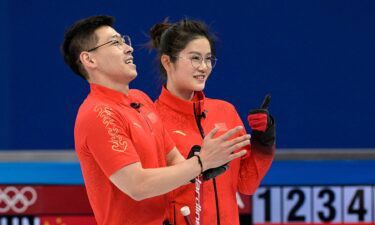 Fan SuYuan and Ling Zhi hold their brooms