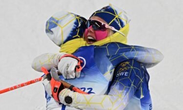 Frist placed Sweden's Jonna Sundling celebrates with finalist Sweden's Emma Ribom (R) in the women's sprint free final event during the Beijing 2022 Winter Olympic Games
