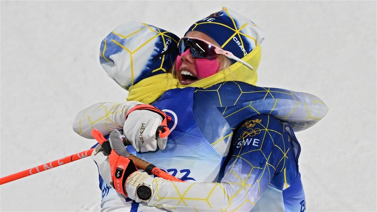 Frist placed Sweden's Jonna Sundling celebrates with finalist Sweden's Emma Ribom (R) in the women's sprint free final event during the Beijing 2022 Winter Olympic Games