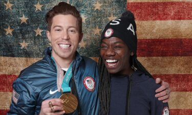 Snowboarder Shaun White of the Team USA poses for a portrait with American speed skater Maame Biney in 2018.