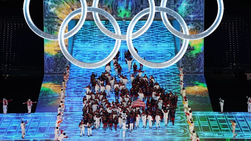 Team USA athletes enter the stadium in Beijing under the Olympic Rings