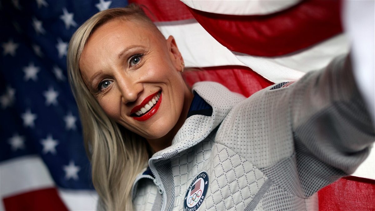 Kaillie Humphries of Team USA poses with the flag during a 2022 Winter Olympics shoot