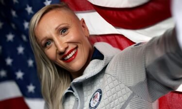 Kaillie Humphries of Team USA poses with the flag during a 2022 Winter Olympics shoot