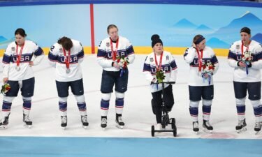 Team USA receives their silver medals with injured player Brianna Decker.