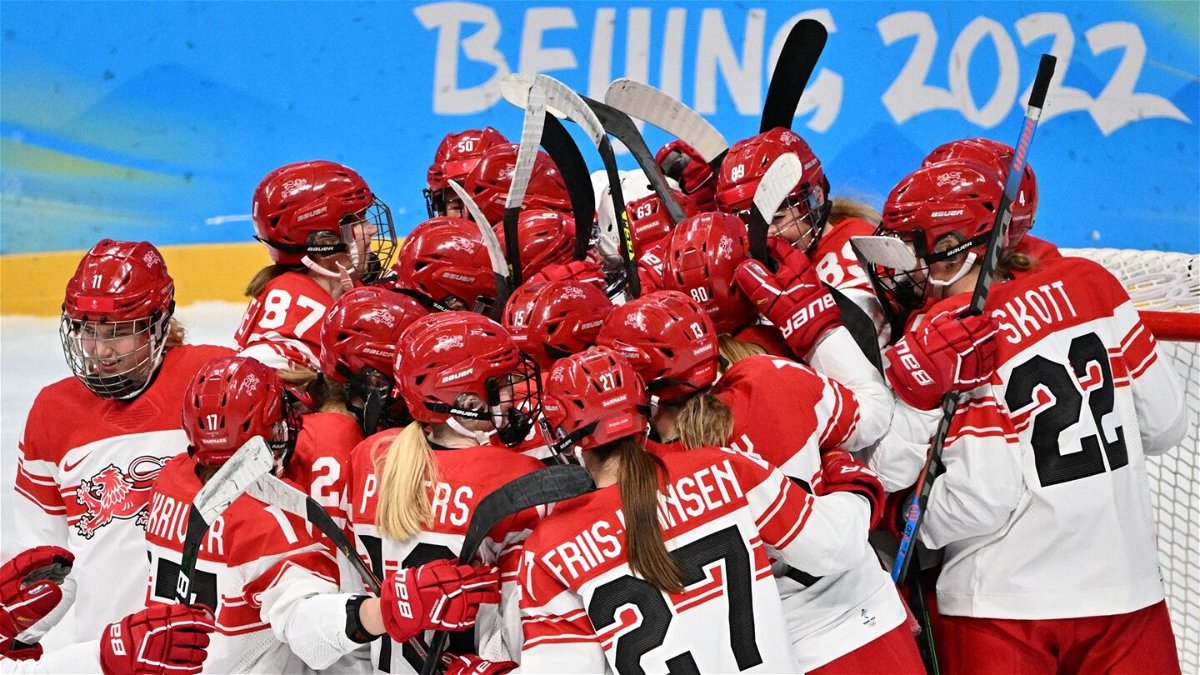 Denmark celebrates after winning first Olympic hockey game.
