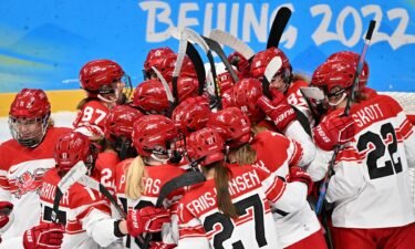 Denmark celebrates after winning first Olympic hockey game.