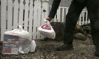 An Instacart worker leaves groceries at the gate of a home in New Hampshire in April 2020.