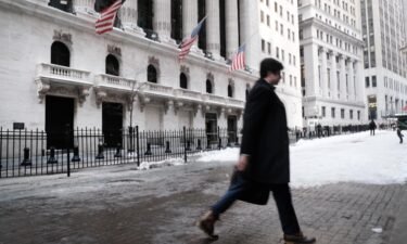 People walk by the New York Stock Exchange (NYSE) on January 31