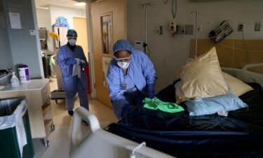 Environmental Services workers Haimanot Gebre (L) and Aster Mekonen deep clean a non-Covid room with disinfectant in the acute care unit at the Harborview Medical Center on January 21
