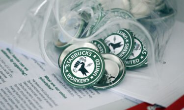 Pro-union pins sit on a table during a watch party for Starbucks' employees union election in 2021.