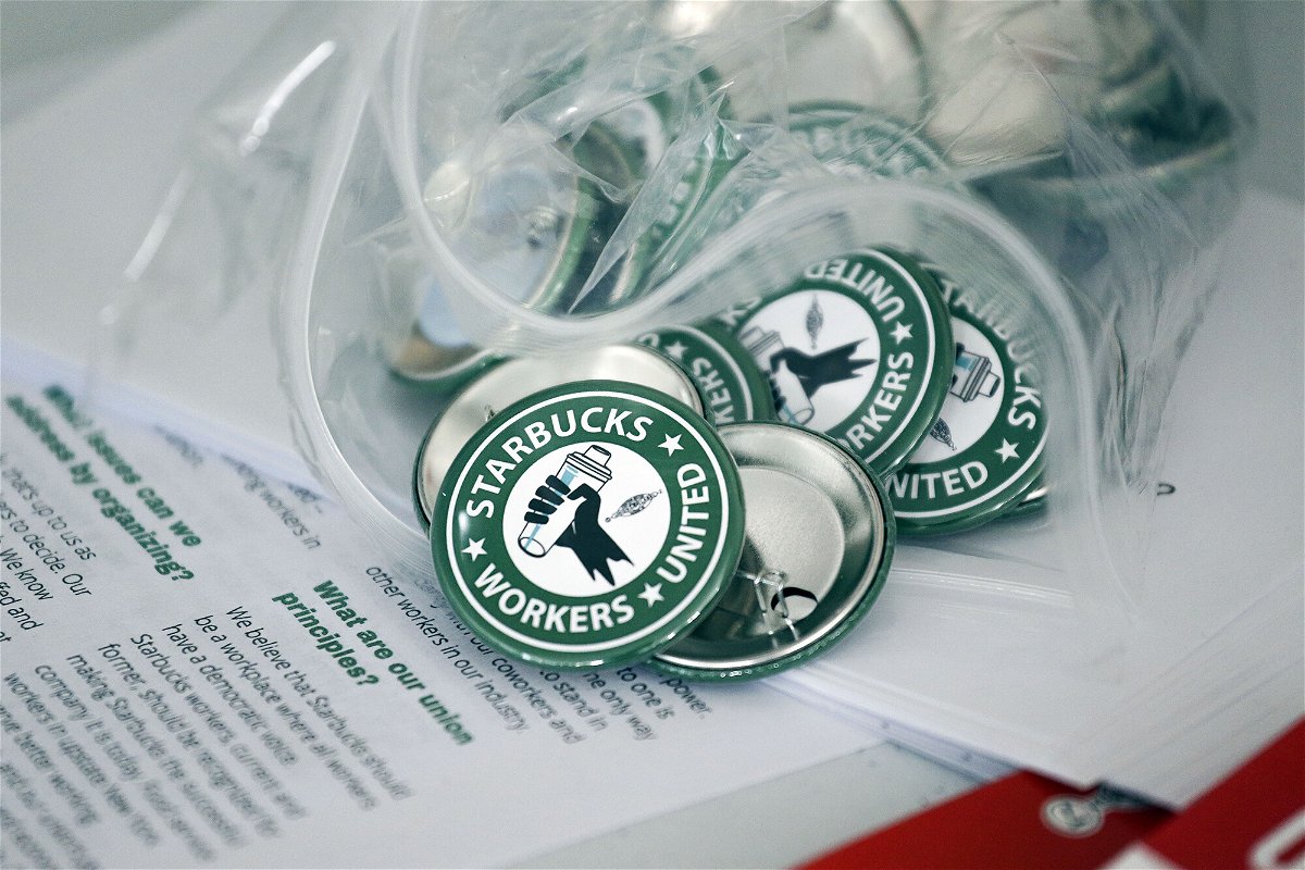 <i>Joshua Bessex/AP</i><br/>Pro-union pins sit on a table during a watch party for Starbucks' employees union election in 2021.