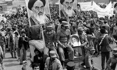 The Iranian Islamic Republic Army demonstrates in solidarity with people in the street during the Iranian revolution. They are carrying posters of the Ayatollah Khomeini