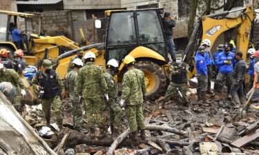 Rescue workers search for survivors after torrential rains triggered a landslide in Quito