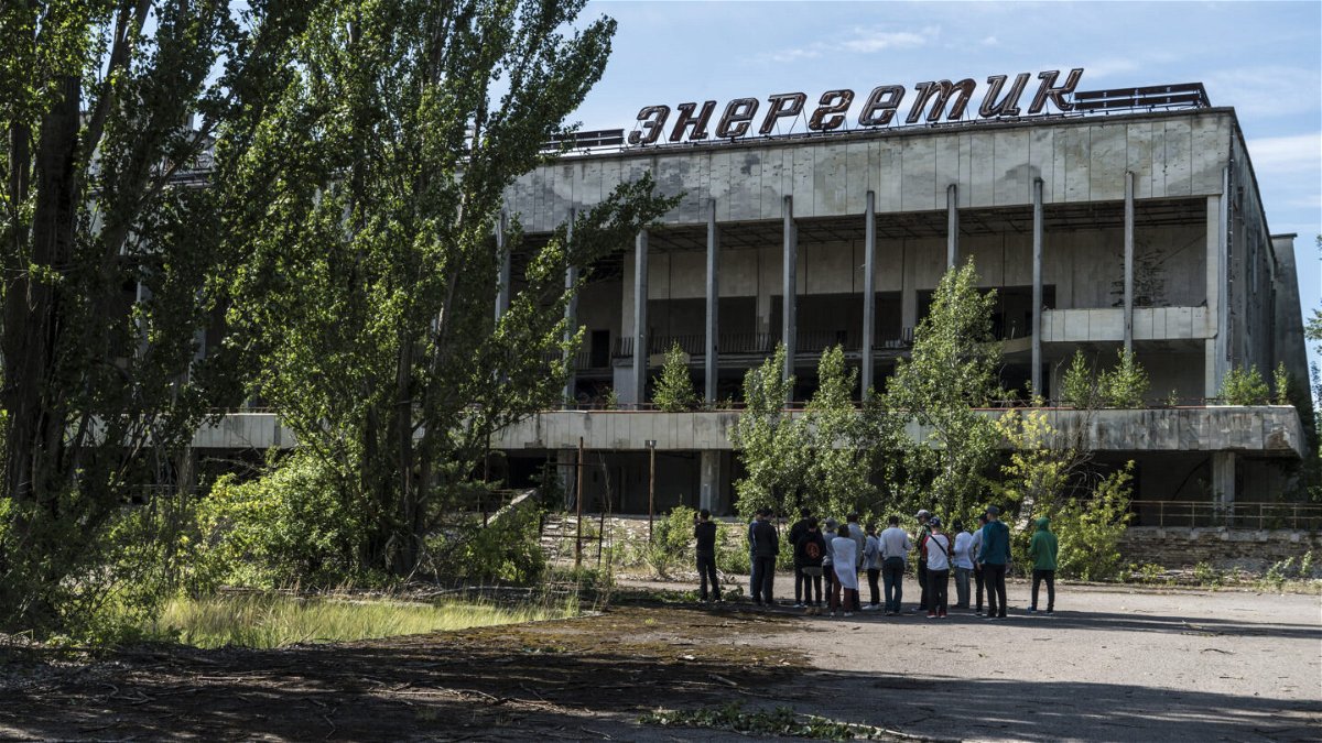 <i>Brendan Hoffman/Getty Images</i><br/>Tourists are guided around the abandoned city of Pripyat