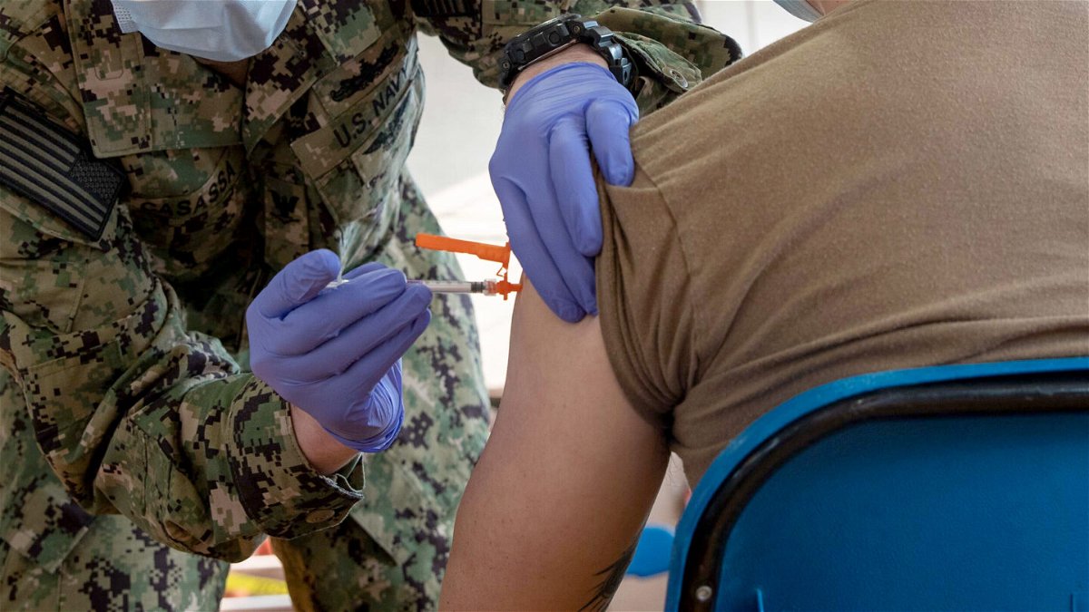 <i>Seaman Jackson Adkins/US Navy</i><br/>A hospital corpsman administers a Covid-19 vaccine aboard Naval Station Norfolk