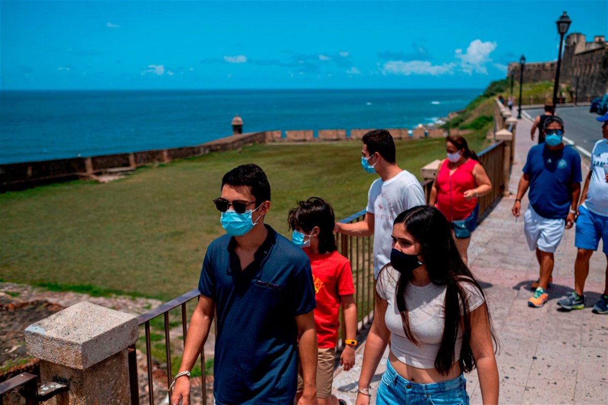 <i>Ricardo Arduengo/AFP via Getty Images</i><br/>Tourists explore Old San Juan
