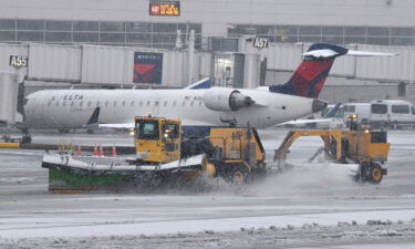 Thousands more flights are canceled as a massive winter storm tears across the US. Pictured is the Detroit Metropolitan Wayne County Airport in Romulus