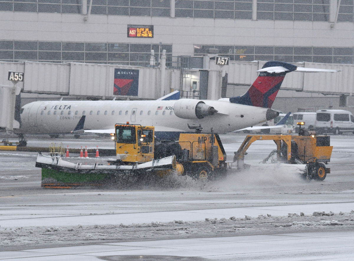 <i>Daniel Mears/AP</i><br/>Thousands more flights are canceled as a massive winter storm tears across the US. Pictured is the Detroit Metropolitan Wayne County Airport in Romulus