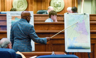 Sen. Rodger Smitherman compares U.S. Representative district maps during a special session on redistricting at the Alabama Statehouse in Montgomery