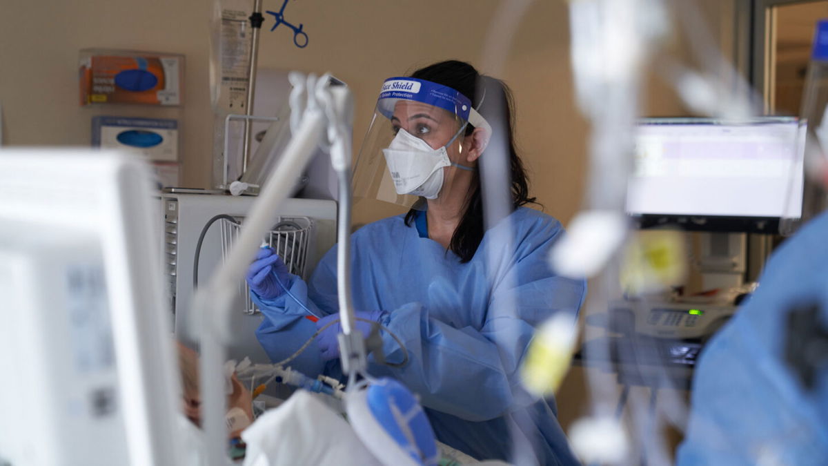 <i>Allison Dinner/Bloomberg via Getty Images</i><br/>A healthcare worker treats a Covid-19 patient on the Intensive Care Unit floor at Hartford Hospital in Hartford