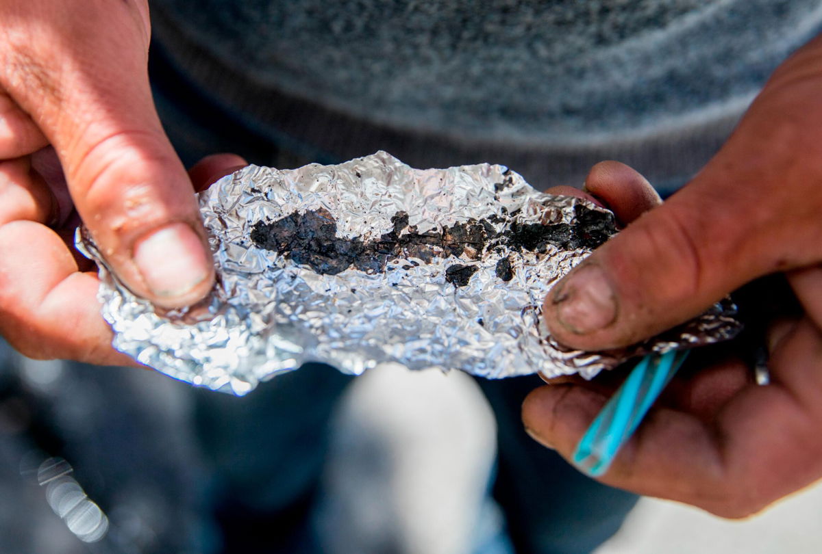 <i>Jessica Christian/San Francisco Chronicle/Getty Images</i><br/>A man holds a piece of foil containing Fentanyl while spending time on in San Francisco