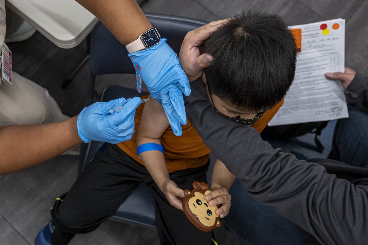 <i>David Paul Morris/Bloomberg/Getty Images</i><br/>A child receives a dose of the Pfizer-BioNTech Covid-19 vaccine at a vaccination clinic at an elementary school in San Jose