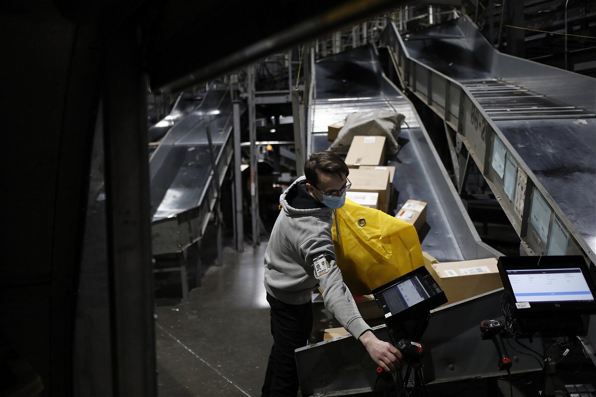 <i>Luke Sharrett/Bloomberg/Getty Images</i><br/>A worker loads packages into a cargo container at the UPS Worldport facility in Louisville
